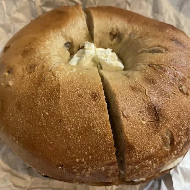 A bagel with Garlic & Herb spread.